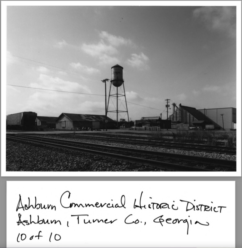 Ashburn Com. Hist. District Application Photo - 10 of 10 - Industrial section, water tower, city jail; photographer facing west.png