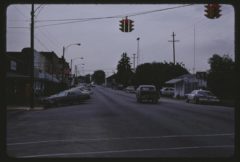 Marshall, Howard W. -  main street, Ashburn GA, police cruisers parked at right - July 1977.jpg