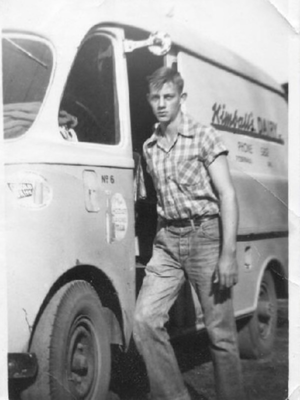 Donald Garrett with his milk truck he drove for delivery.png